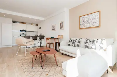 a balcony with white chairs and a sign on it at XXL 2 beds with XXL terrace next to Martinez Hotel in Cannes