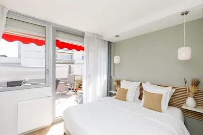 a balcony with tables and chairs and a building at XXL 2 beds with XXL terrace next to Martinez Hotel in Cannes