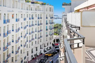 a white bedroom with a large white bed with pillows at XXL 2 beds with XXL terrace next to Martinez Hotel in Cannes