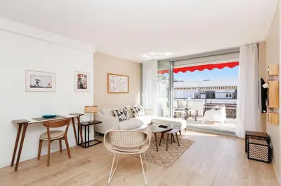 a living room with a couch and a table at XXL 2 beds with XXL terrace next to Martinez Hotel in Cannes