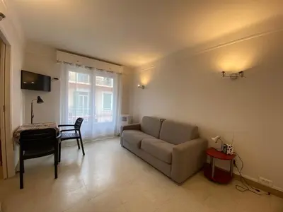 a living room with a couch and a table at C048 Studio Spacieux proche Plages et Palais in Cannes