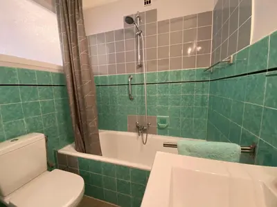 a bathroom with a toilet and a tub and a sink at C048 Studio Spacieux proche Plages et Palais in Cannes