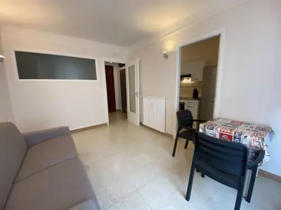 a living room with a couch and a table and chairs at C048 Studio Spacieux proche Plages et Palais in Cannes