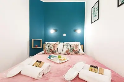 a room with a bed with a tray of food on it at Chagall 3 étoiles in Cannes