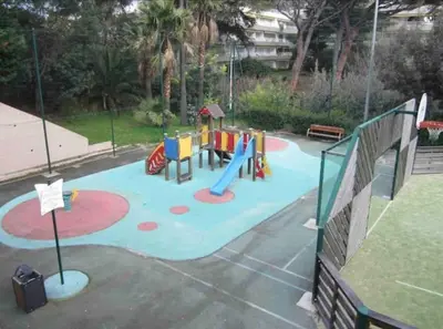 a playground with a slide in a park at Chagall 3 étoiles in Cannes