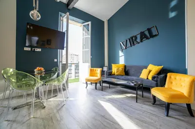 a living room with a couch and a table at The Loft - Superb 2 bedrooms on top floor with terrace - 10min to Palais & Beach! in Cannes