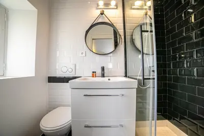 a bathroom with a toilet and a sink and a mirror at The Loft - Superb 2 bedrooms on top floor with terrace - 10min to Palais & Beach! in Cannes