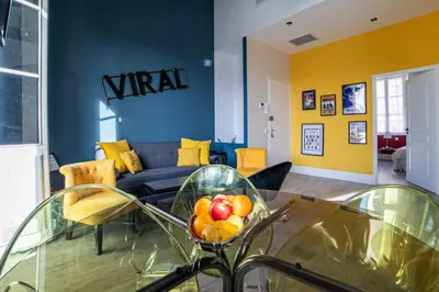 a living room with a couch and a bowl of fruit on a table at The Loft - Superb 2 bedrooms on top floor with terrace - 10min to Palais & Beach! in Cannes
