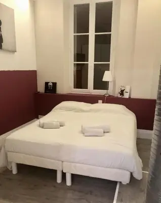 a bedroom with a large white bed with two pillows at The Loft - Superb 2 bedrooms on top floor with terrace - 10min to Palais & Beach! in Cannes