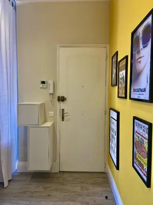 a room with a white door and pictures on the wall at The Loft - Superb 2 bedrooms on top floor with terrace - 10min to Palais & Beach! in Cannes