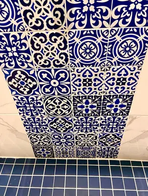 a blue and white tile wall in a bathroom at Le somptueux Le Gallia in Cannes
