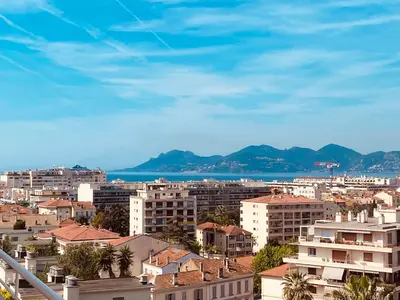 a city with buildings and the ocean in the background at Le somptueux Le Gallia in Cannes