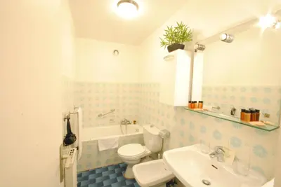 a bathroom with a white toilet and a sink at antares57 in Cannes