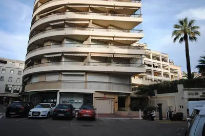 a building with cars parked in front of it at antares57 in Cannes