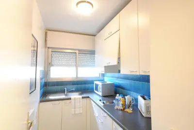 a kitchen with a sink and a microwave at antares57 in Cannes