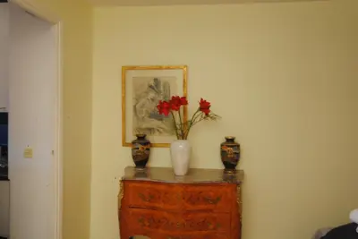 a table with two vases and a vase with flowers on it at antares57 in Cannes