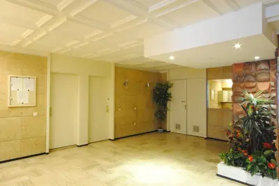 an empty room with a hallway with a plant at antares57 in Cannes