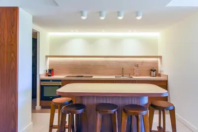 a kitchen with a counter with stools around a kitchen island at Luxurious apartment with terrace 6P - 3BR - Grand in Cannes