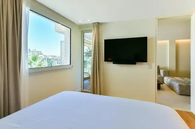 a bedroom with a large bed and a large window at Luxurious apartment with terrace 6P - 3BR - Grand in Cannes