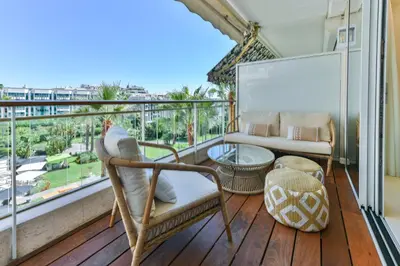 a balcony with chairs and a table and a couch at Luxurious apartment with terrace 6P - 3BR - Grand in Cannes