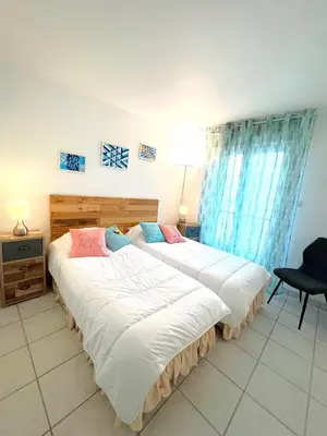 two beds sitting in a room with at Palazzio 3, quartier vieux port avec parking, by Welcome to Cannes in Cannes