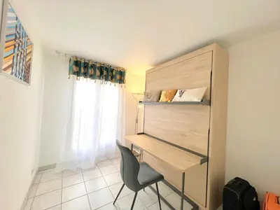 a desk and a chair in a room with a window at Palazzio 3, quartier vieux port avec parking, by Welcome to Cannes in Cannes