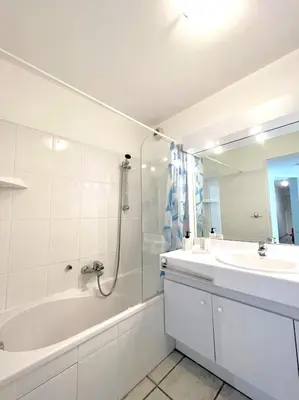 a white bathroom with a tub and a sink at Palazzio 3, quartier vieux port avec parking, by Welcome to Cannes in Cannes