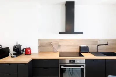 a kitchen with a sink and a counter top at Palladium 148 YourHostHelper in Cannes