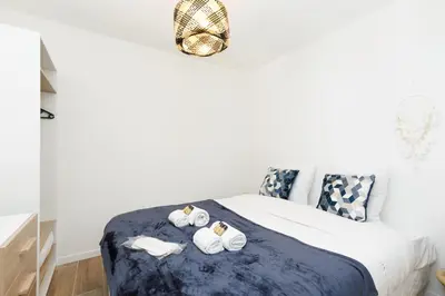 a bedroom with a bed with towels on it at Palladium 148 YourHostHelper in Cannes