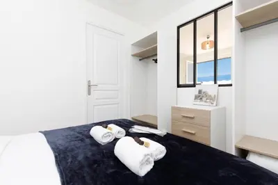 a bedroom with a bed with towels on it at Palladium 148 YourHostHelper in Cannes