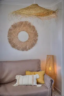 a living room with a couch and a mirror at IMMOGROOM - Renovated - Sea view - Pool - Patio - Wifi - AC - Parking in Cannes
