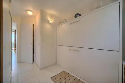 a kitchen with a large white refrigerator in a room at IMMOGROOM - Renovated - Sea view - Pool - Patio - Wifi - AC - Parking in Cannes