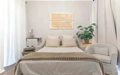 a white bedroom with a bed and a chair at Bel Appartement 5* Vue Mer Et Suquet - Centre Cannes in Cannes