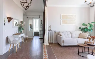 a living room with a white couch and a table at Bel Appartement 5* Vue Mer Et Suquet - Centre Cannes in Cannes
