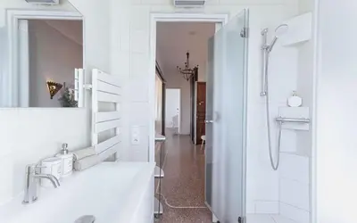 a white bathroom with a shower and a sink at Bel Appartement 5* Vue Mer Et Suquet - Centre Cannes in Cannes