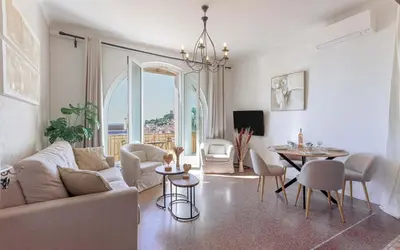 a living room with a couch and a table at Bel Appartement 5* Vue Mer Et Suquet - Centre Cannes in Cannes