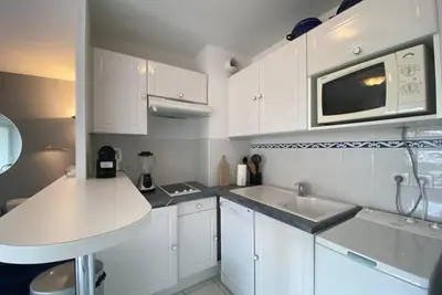 a kitchen with white cabinets and a microwave and a sink at C057-Appart fonctionnel - 4 Pers - Cannes Suquet-Clemenceau in Cannes