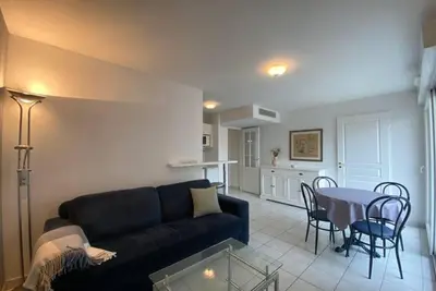 a living room with a couch and a table with chairs at C057-Appart fonctionnel - 4 Pers - Cannes Suquet-Clemenceau in Cannes