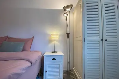 a bedroom with a bed and a lamp on a night stand at C057-Appart fonctionnel - 4 Pers - Cannes Suquet-Clemenceau in Cannes