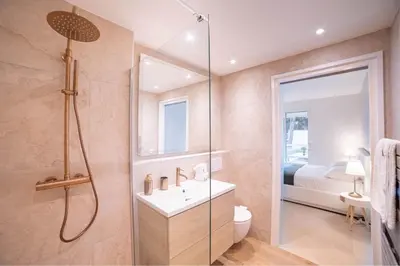 a bed with towels and a clock on it at Dream Apartment by Halldis in Cannes