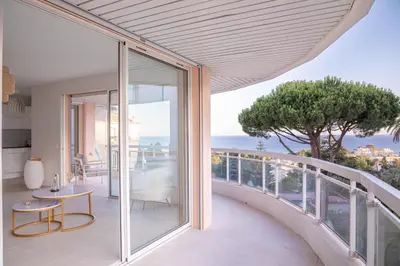 a kitchen and dining room with a view of the ocean at Dream Apartment by Halldis in Cannes