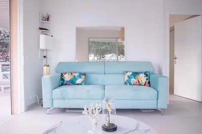 a white bedroom with a bed and a window at Dream Apartment by Halldis in Cannes