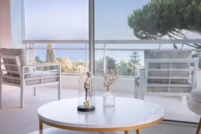 a view of a city with palm trees and the ocean at Dream Apartment by Halldis in Cannes