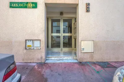 an entrance to a building with a glass door at Appartement Berthelotine - Welkeys in Cannes