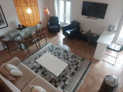a living room with a couch and a table at Place du Suquet - In the hart of old Cannes - 2 Min Walking distance from Palais de Festivals and Beaches in Cannes