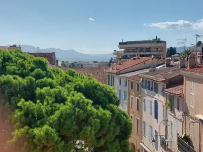 a building with a statue in the middle of a street at Place du Suquet - In the hart of old Cannes - 2 Min Walking distance from Palais de Festivals and Beaches in Cannes