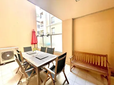 a dining room with a table and a bench at Jolie 3 pièces avec terrasse au vieux port, à 2 pas des plages et du palais. in Cannes