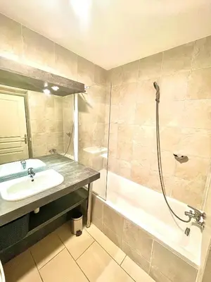 a bathroom with a sink and a shower and a tub at Jolie 3 pièces avec terrasse au vieux port, à 2 pas des plages et du palais. in Cannes