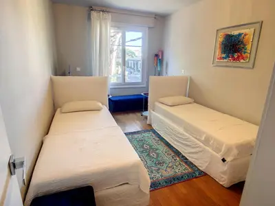 two beds in a room with a window at 2 bedroom, 2 bathrooms Suquet with sea view 314 in Cannes