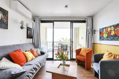 a living room with a couch and a table at Résidence Cannes Villa Francia - maeva Home - Appartement 2 Pièces 4 Personnes - Prestige MAE-8674 in Cannes